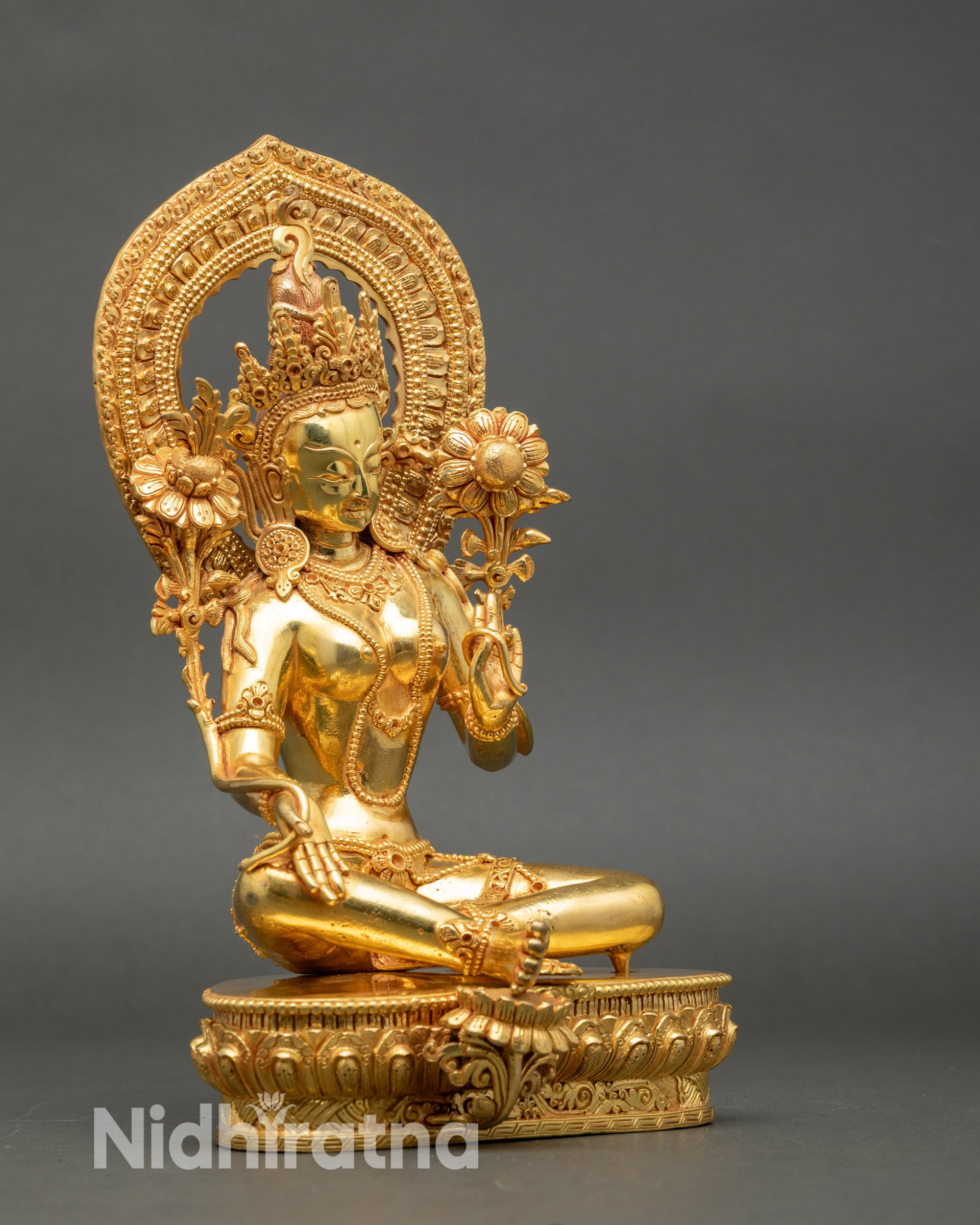 Right profile of Green Tara statue in Lalitasana posture with halo and lotus seat