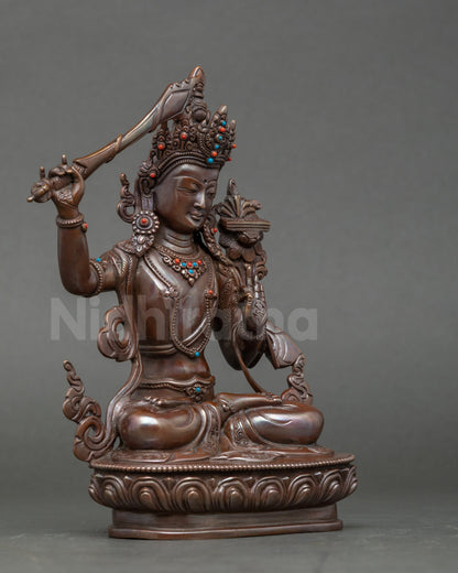 Side view Manjushri Buddha sculpture, seated on lotus throne holding flaming sword
