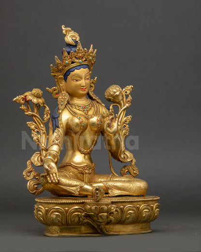 Side view Green Tara statue holding utpala flower, royal ease posture, Tibetan deity