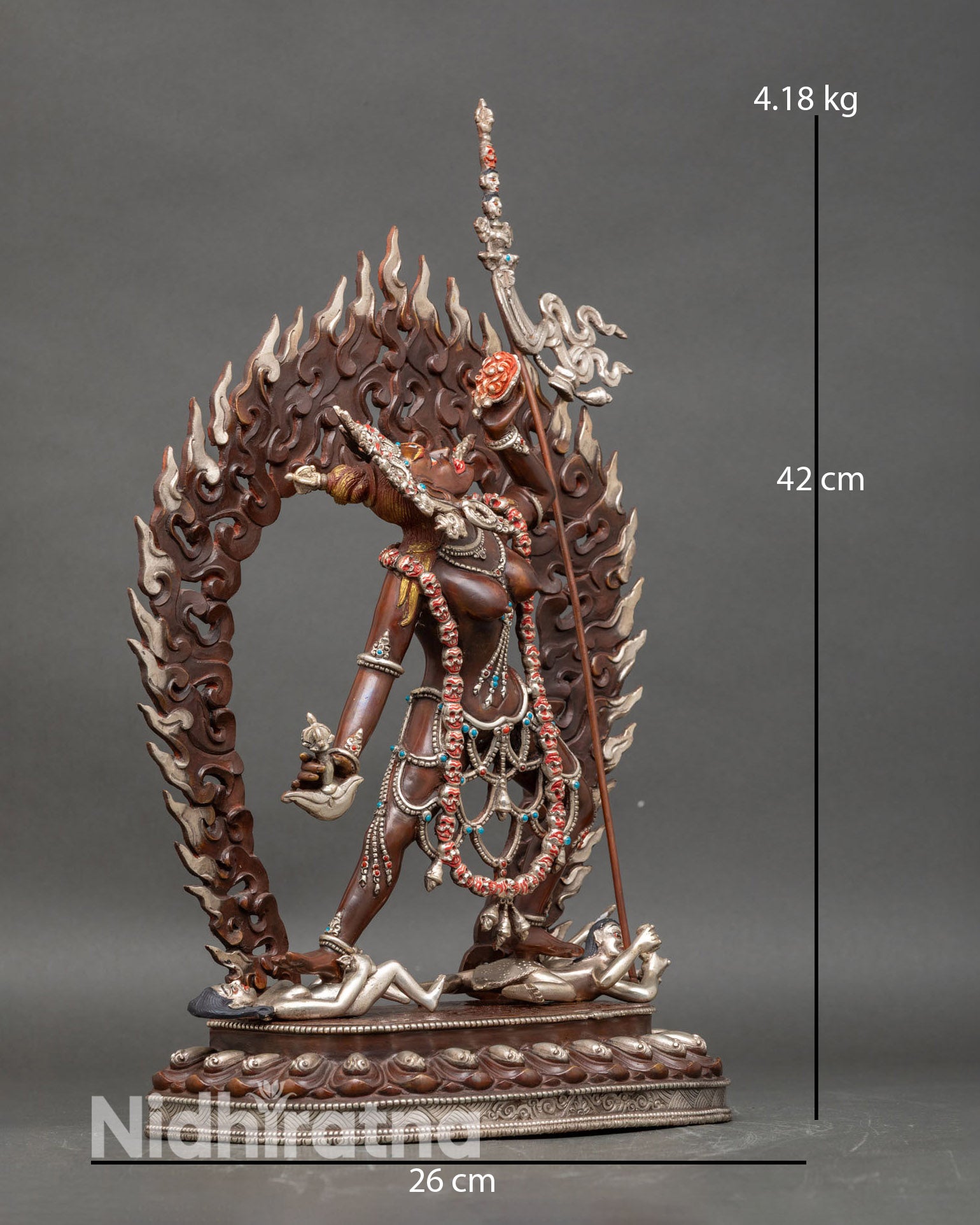 Side view of Vajrayogini statue standing on subdued figures symbolism tantric Buddhist sculpture