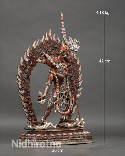 Side view of Vajrayogini statue standing on subdued figures symbolism tantric Buddhist sculpture