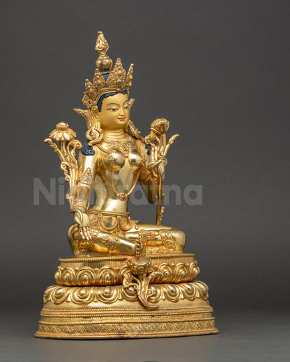 Side view Green Tara in royal ease posture holding blue utpala lotus, Vajrayana deity