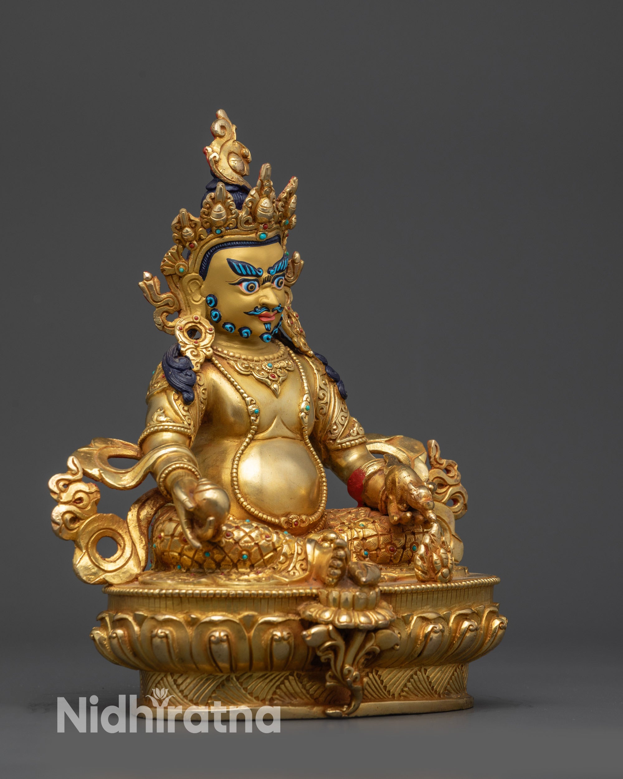 Right side view of Dzambhala statue holding citron fruits and spitting jewels.