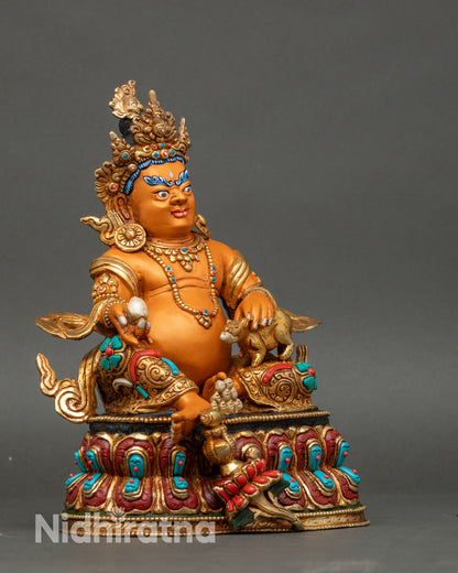 Right profile of Tibetan Dzambhala statue seated on lotus pedestal