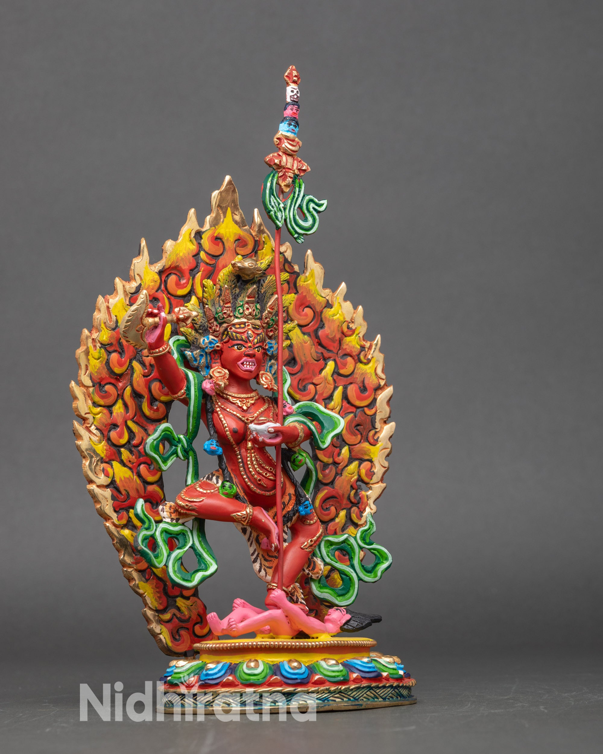 Side view Dorje Phagmo sculpture holding flaying knife skull cup and trident