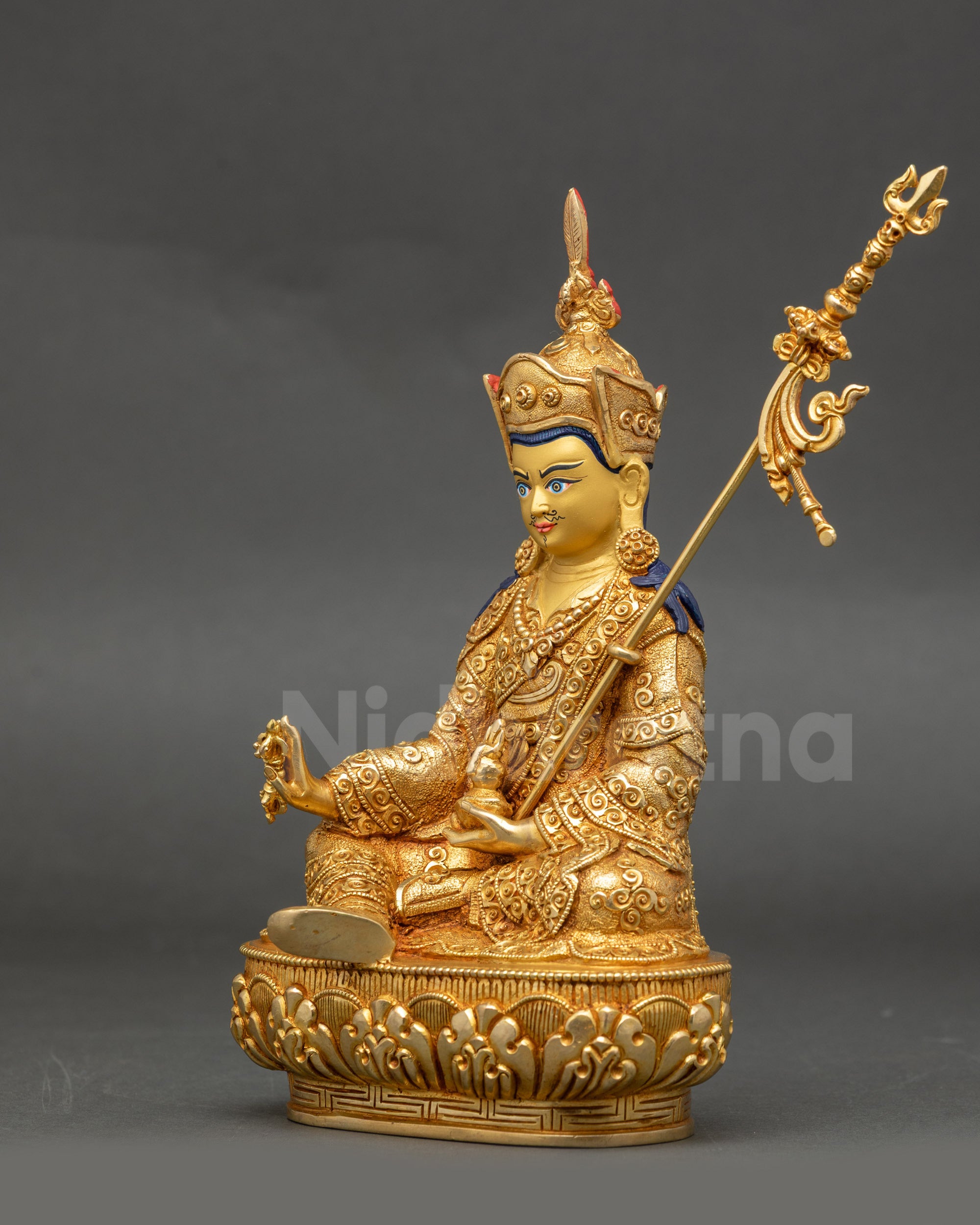 Top angle of Guru Rinpoche statue highlighting intricate robes and ornaments