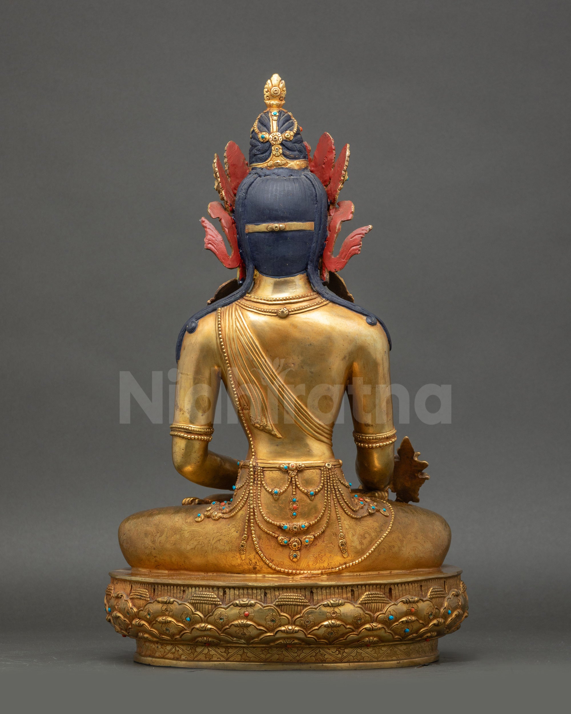 Back view Medicine Buddha statue seated on lotus base, Buddhist healing decor