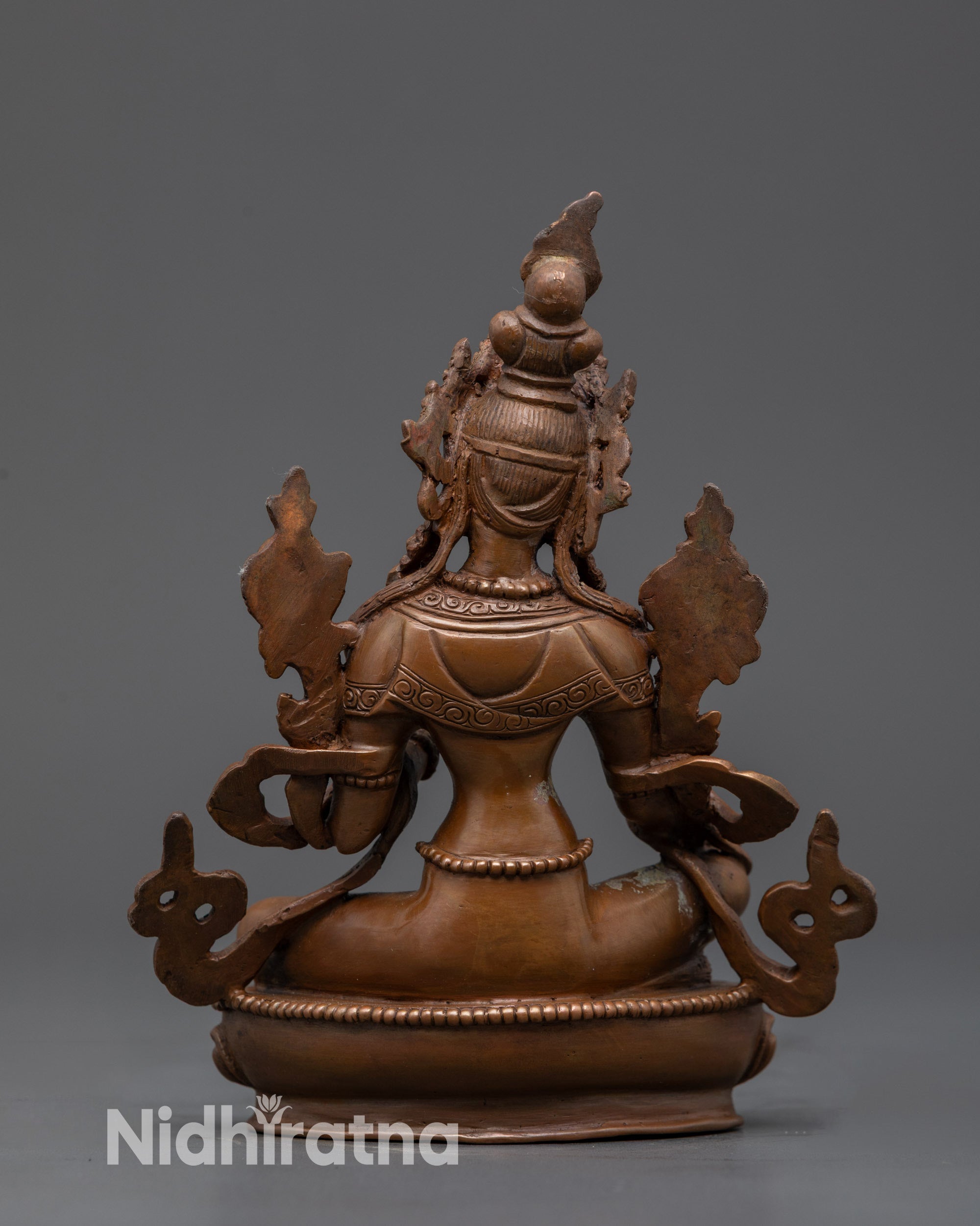 Back view Oxidized Copper Green Tara Statue highlighting carved lotus seat and flowing robe
