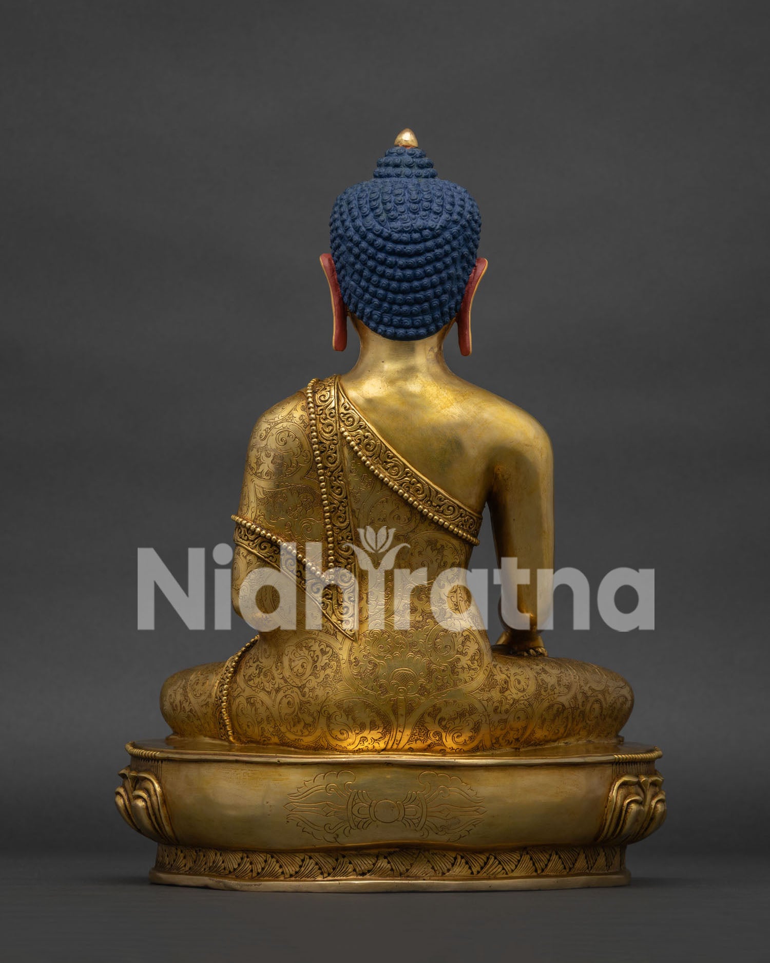 Back view of handcrafted copper Shakyamuni Buddha statue showing detailed monastic robe