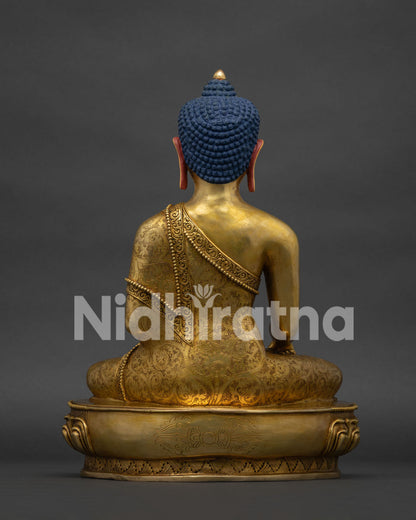 Back view of handcrafted copper Shakyamuni Buddha statue showing detailed monastic robe