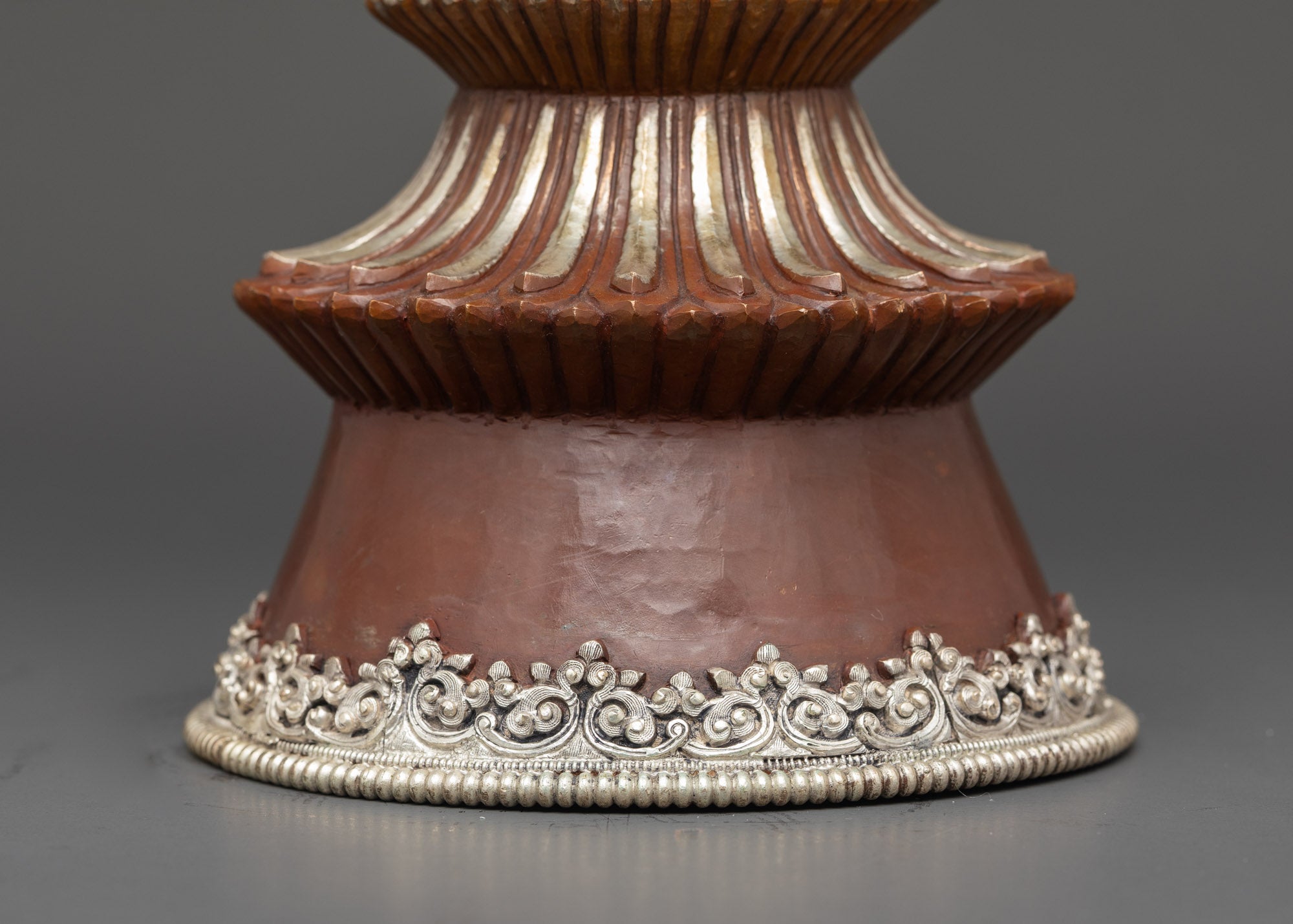 Base view handcrafted Tibetan Butter Lamp with silver plating and decorative floral carvings