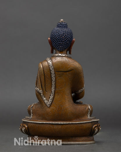 Back view of traditional Amitabha Buddha statue with lotus pedestal and sacred detailing