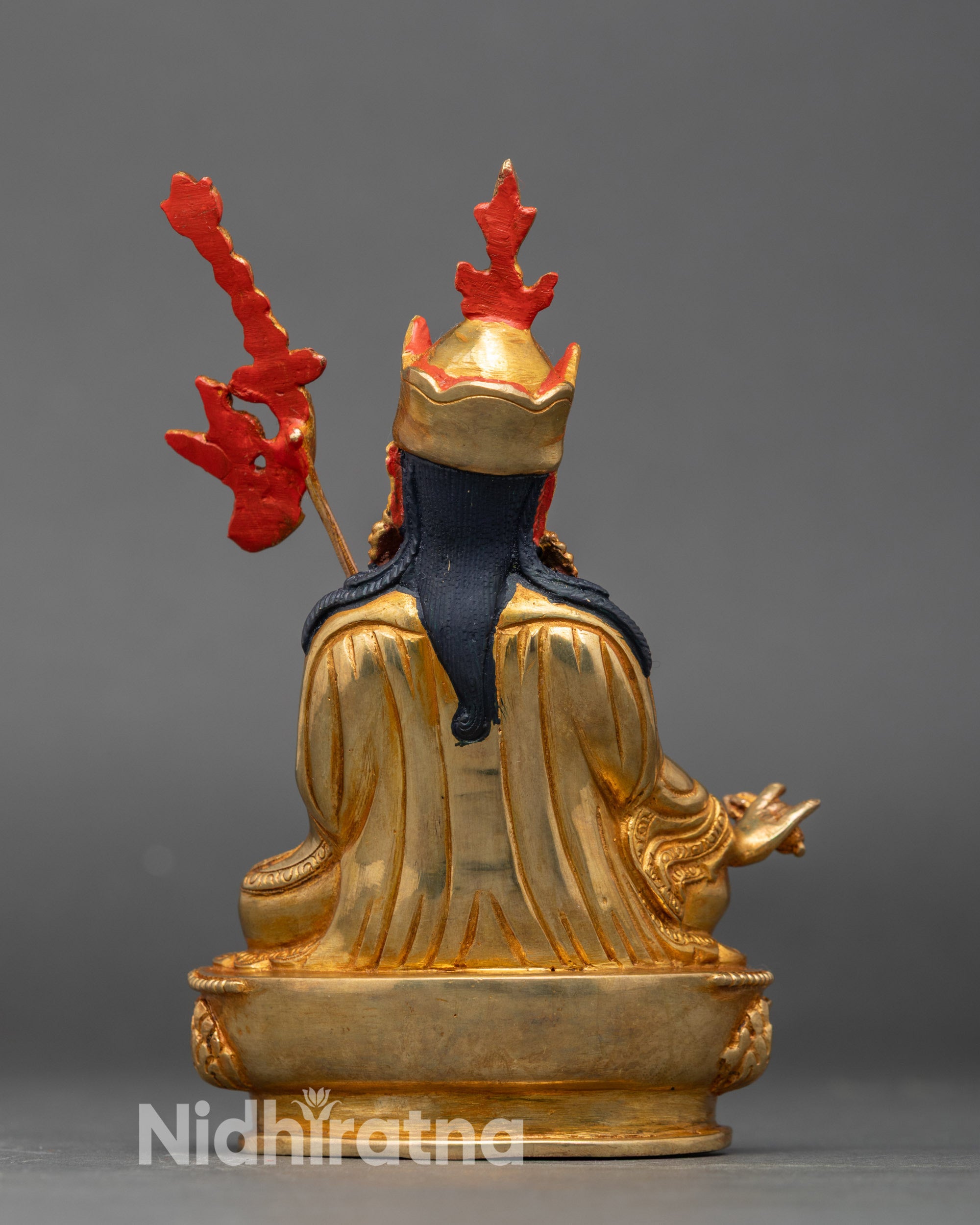 Back view of Padmasambhava copper statue, highlighting gold fire-gilding and traditional Himalayan design