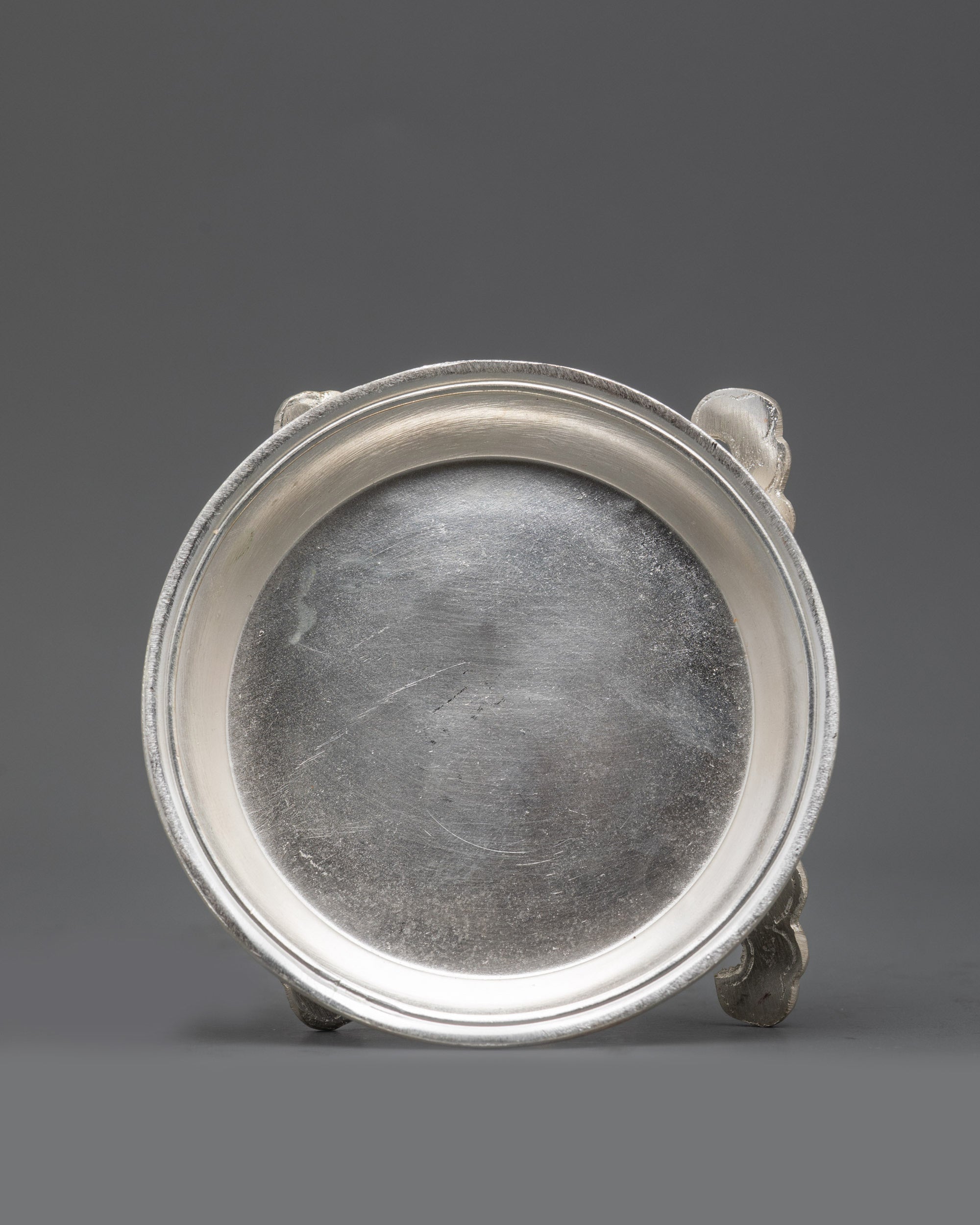 Side view seven silver-plated water offering bowls from Tibetan Torjang Set