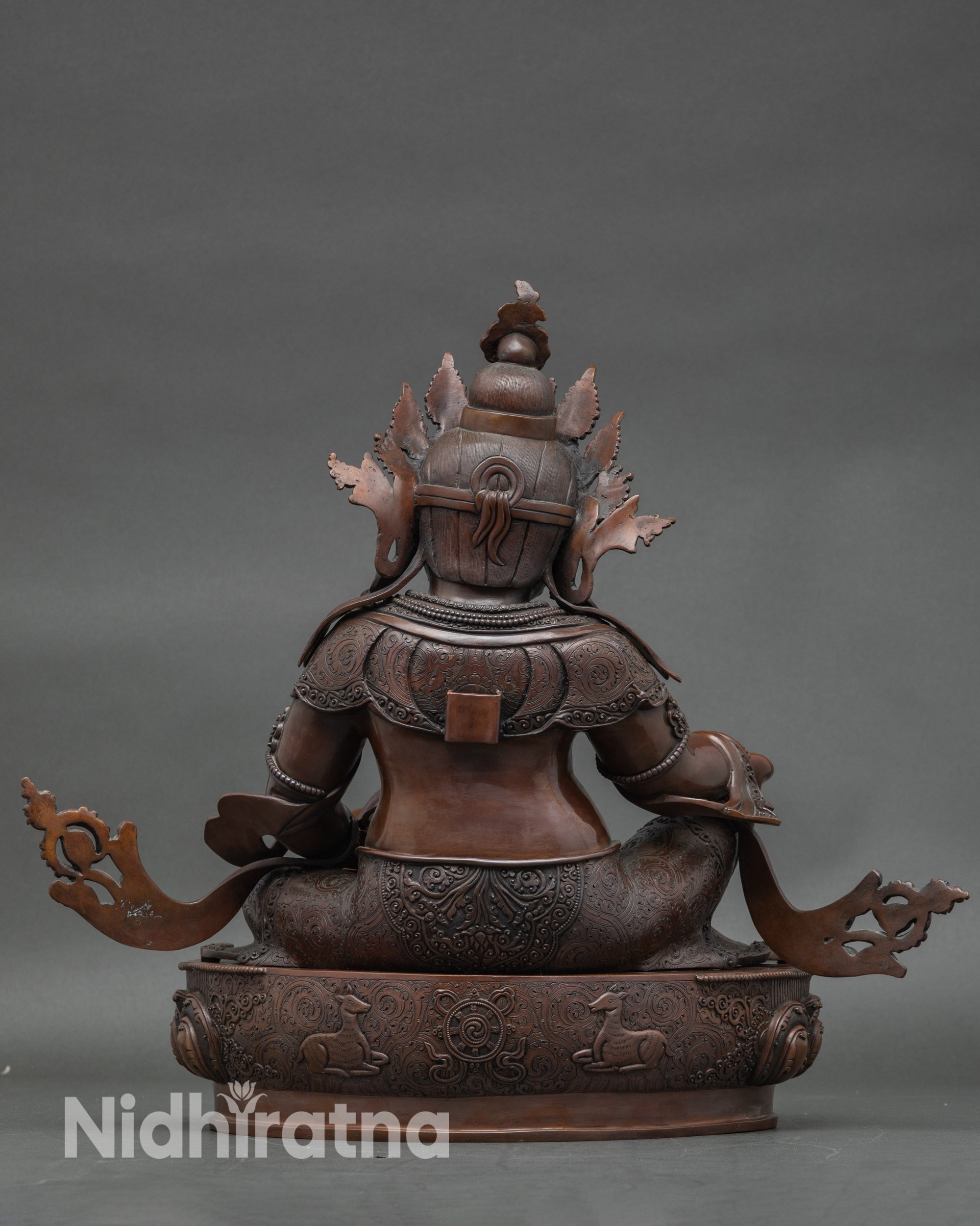 Back view Dzambhala statue showing ornate flaming halo and detailed lotus base, spiritual décor