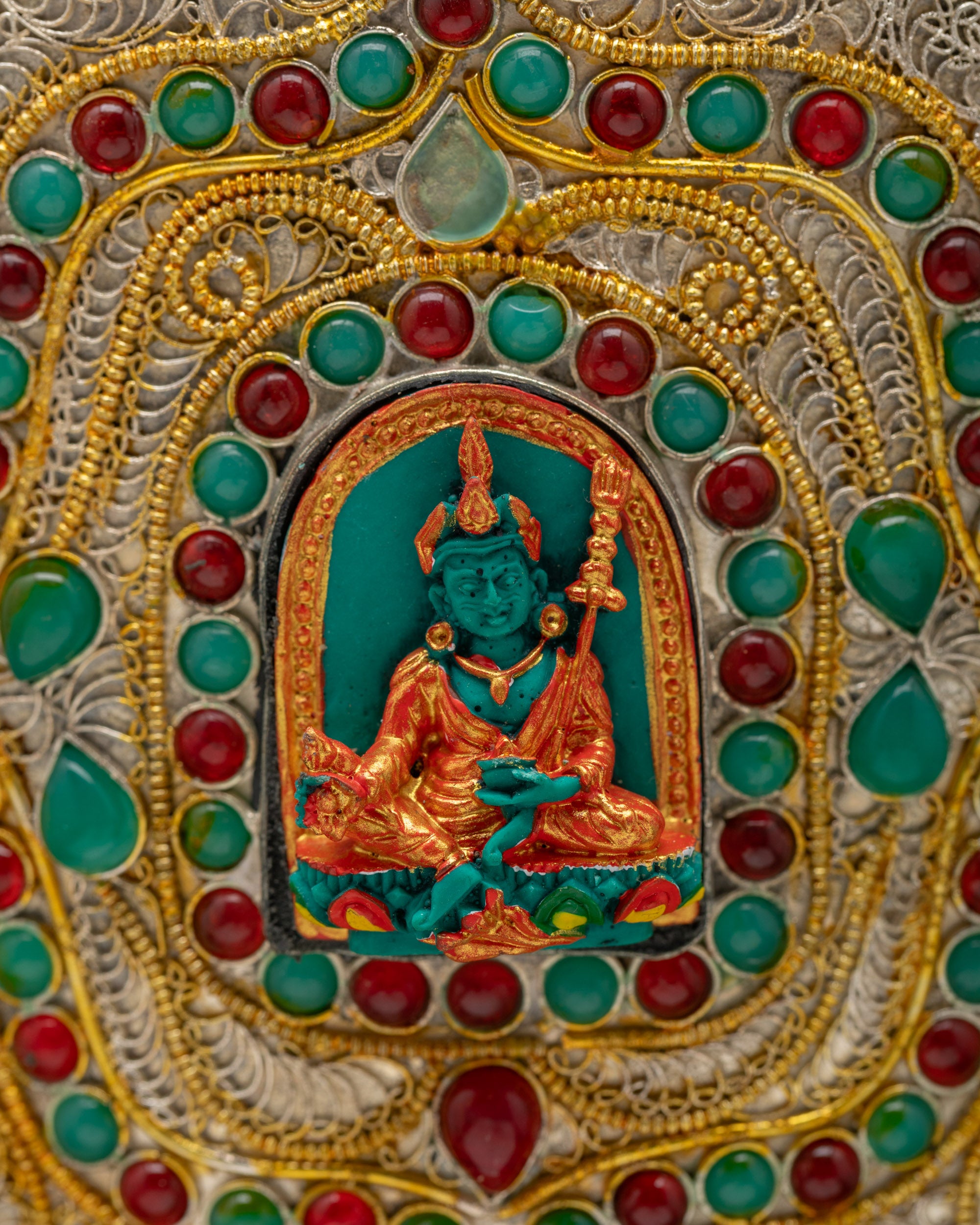 Detailed view of Guru Rinpoche figure on silver and gold-plated Himalayan Vase symbolizing wisdom and spiritual protection.