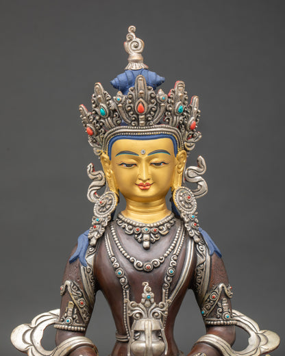 Close-up of Amitayus Buddha statue showing intricate silver oxidation and semi-precious stone detailing