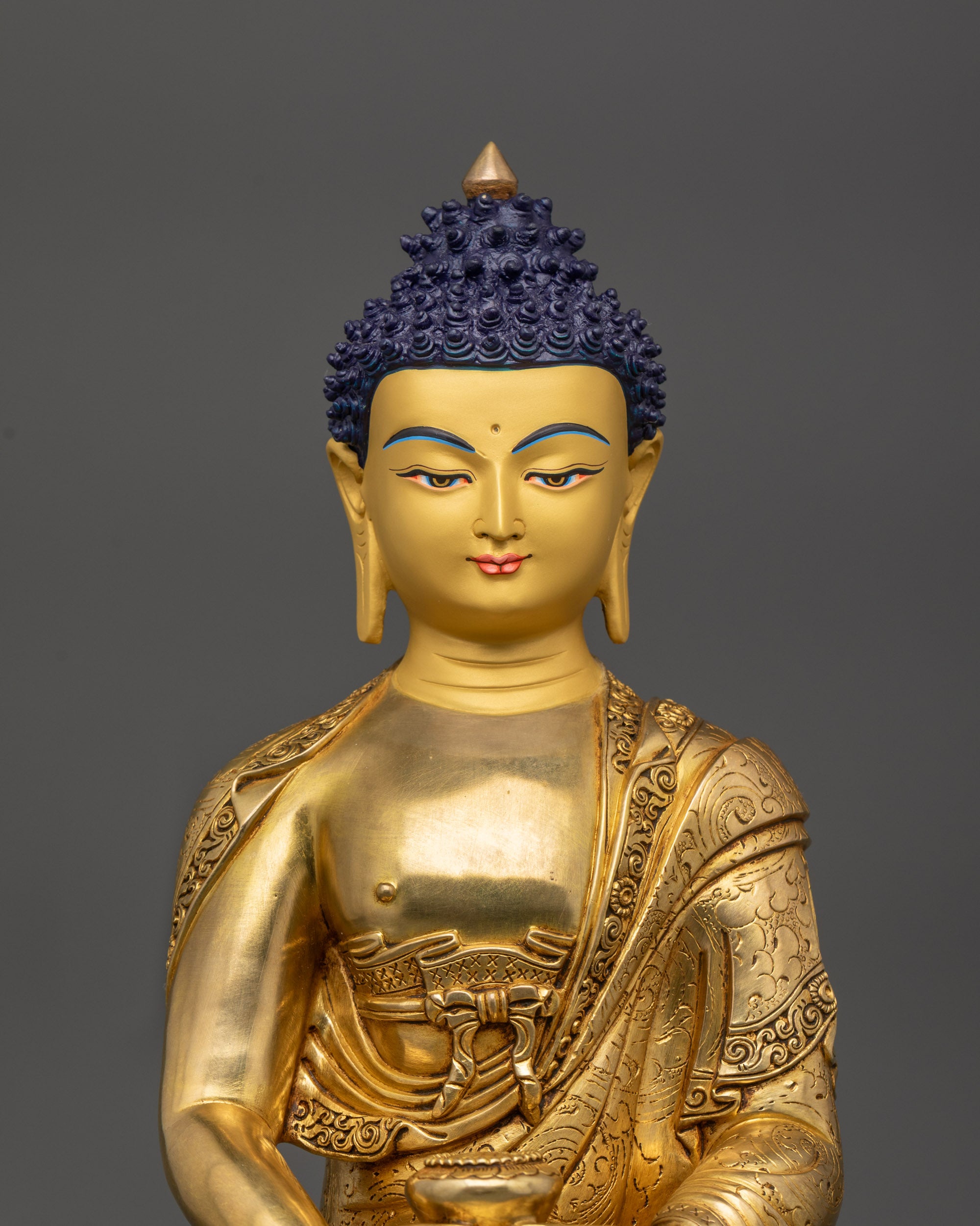 Close up Amitabha Buddha face with 24K gold-gilded details and serene expression