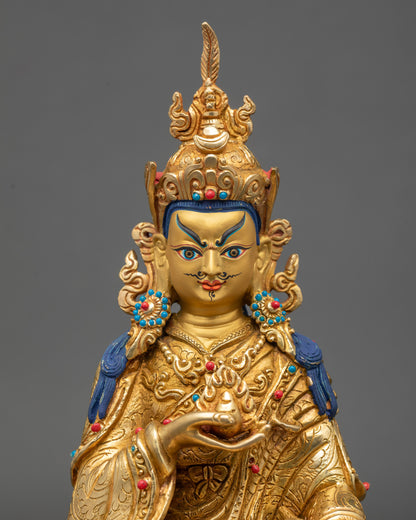 Close up Guru Norlha face, gold-painted expression with semi-precious stone details