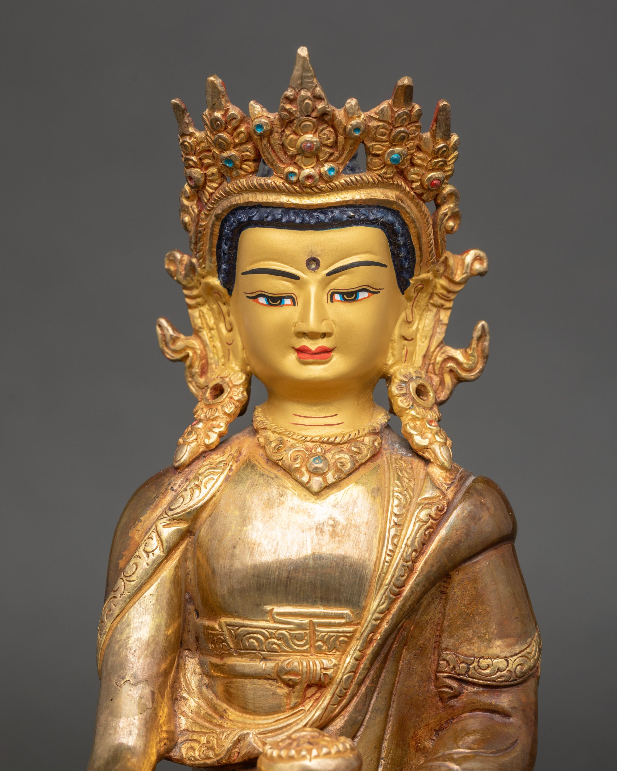 Regular close up Buddha Shakyamuni Statue showing crown, earrings, and monk’s robe details

