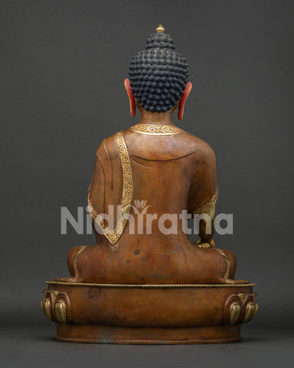 Back view of Shakyamuni Buddha statue showing hair curls and robe design