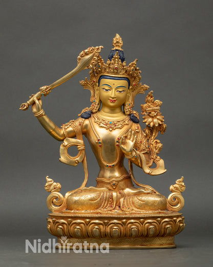 Front view Manjushri statue with utpala flower, double-edged sword, lotus throne
