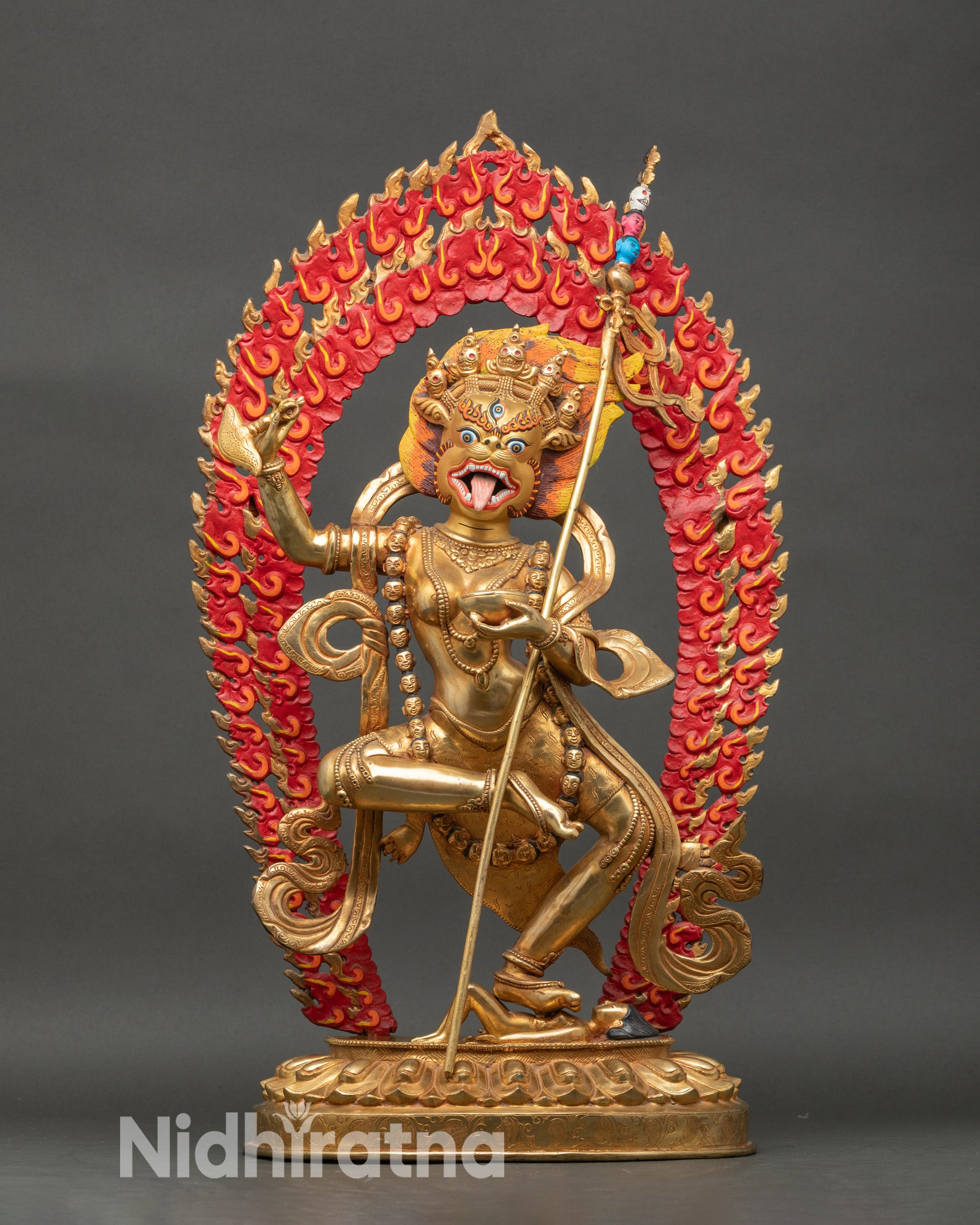 Front view Simhamukha statue with lion face, third eye, lotus seat, and fierce stance