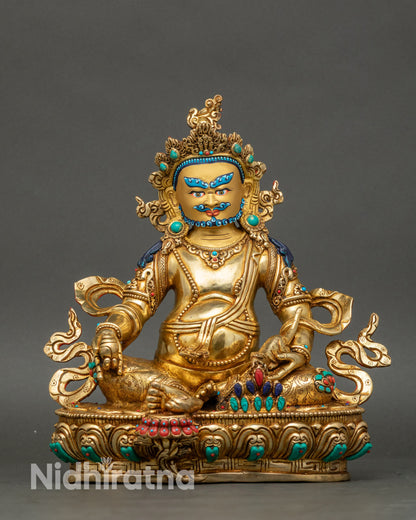 Front view Dzambhala statue gold-gilded copper seated on lotus base wealth deity Nepal