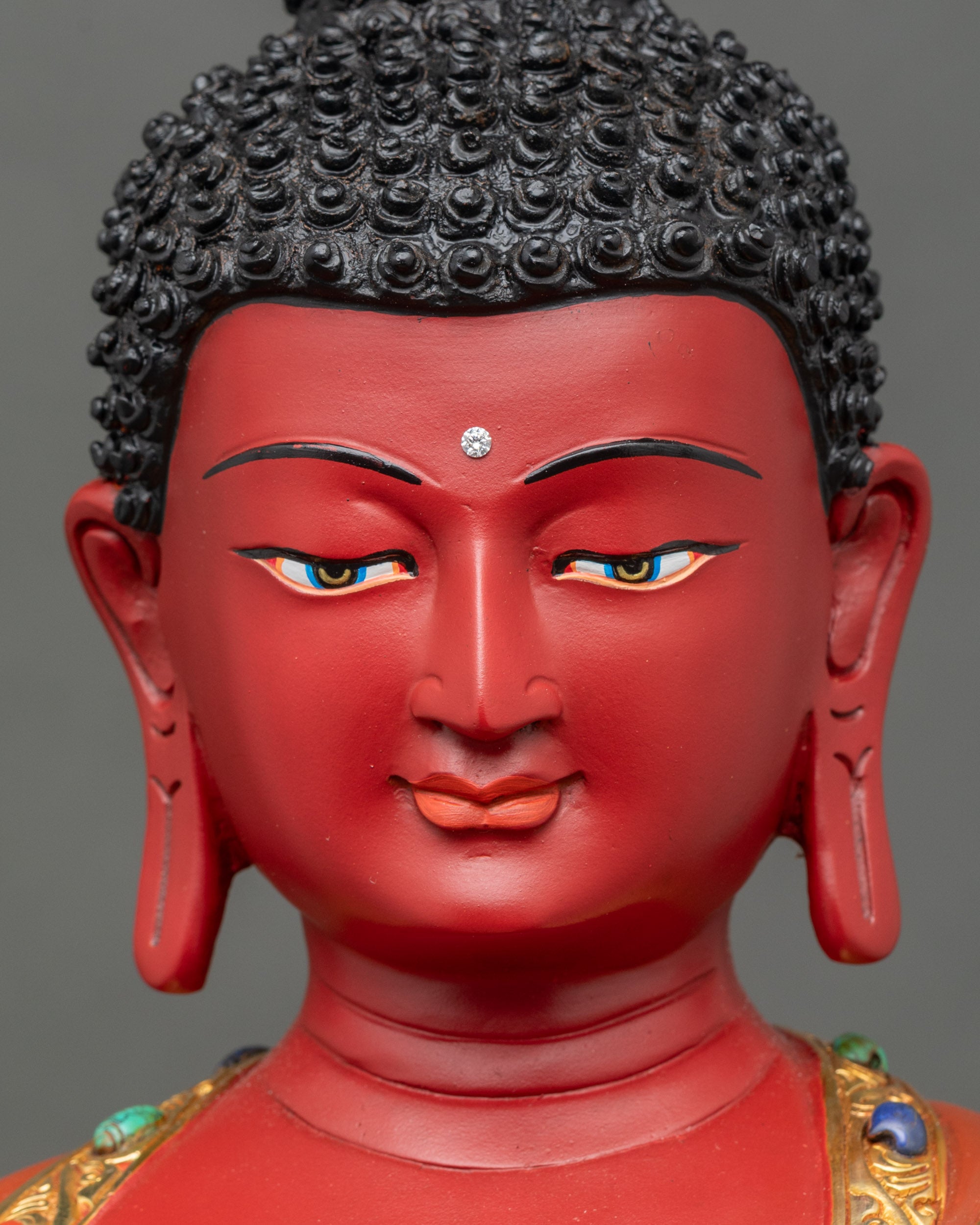 Face close-up of Amitabha Buddha, serene expression with halo, gold fire-gilded meditation statue