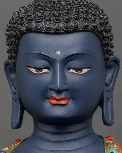 Face close-up of Bhaisajyaguru statue, peaceful expression with semi-precious stone accents