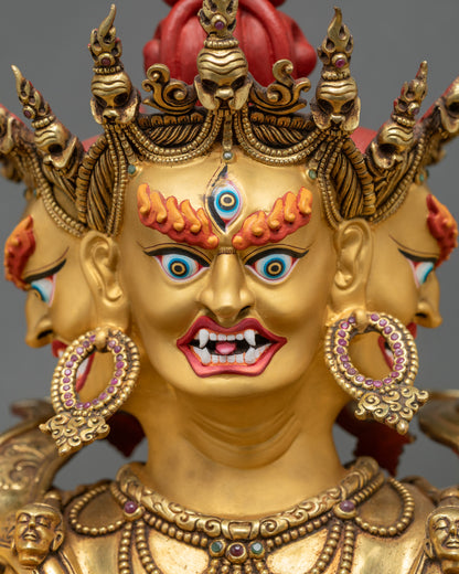 Face close-up of Kalachakra Statue showing fierce expression and gold gilding