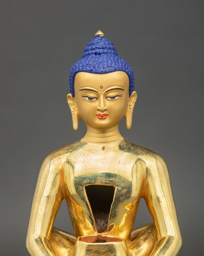 Face close up of Samantabhadra Primordial Buddha, serene gold gilded detail