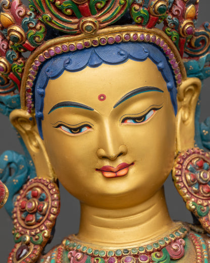 Face detail of Green Tara Meditation statue, gold painted face with serene expression