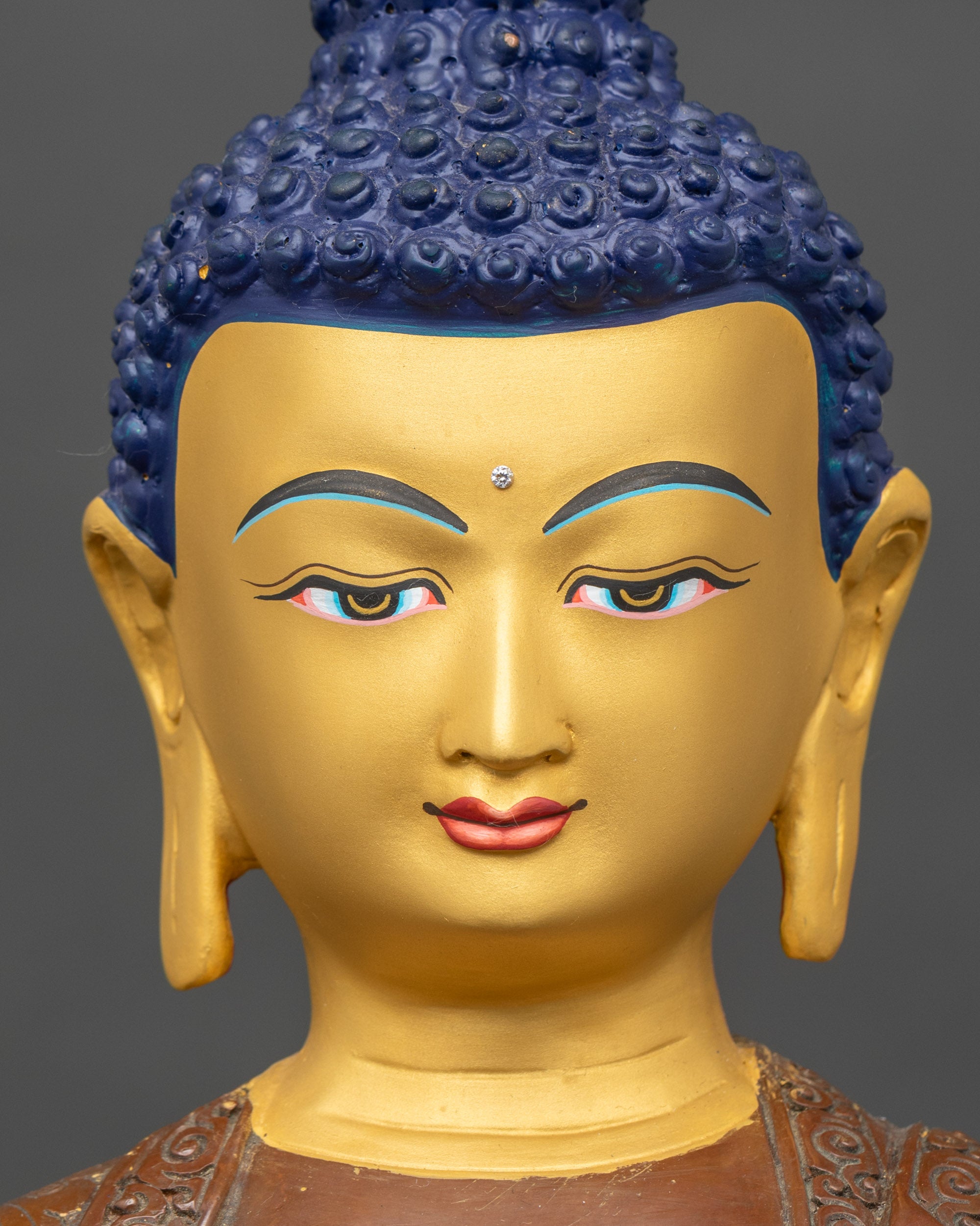 Face of oxidized copper Buddha statue, hand-painted gold, serene meditation expression
