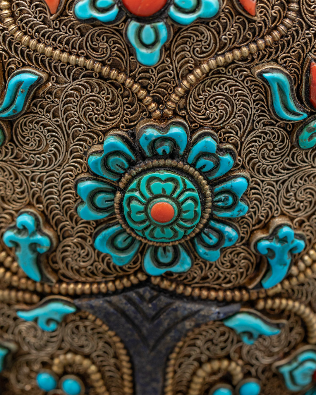 Flower-shaped Tibetan offering bowl side view with turquoise stones