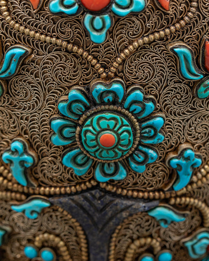 Flower-shaped Tibetan offering bowl side view with turquoise stones