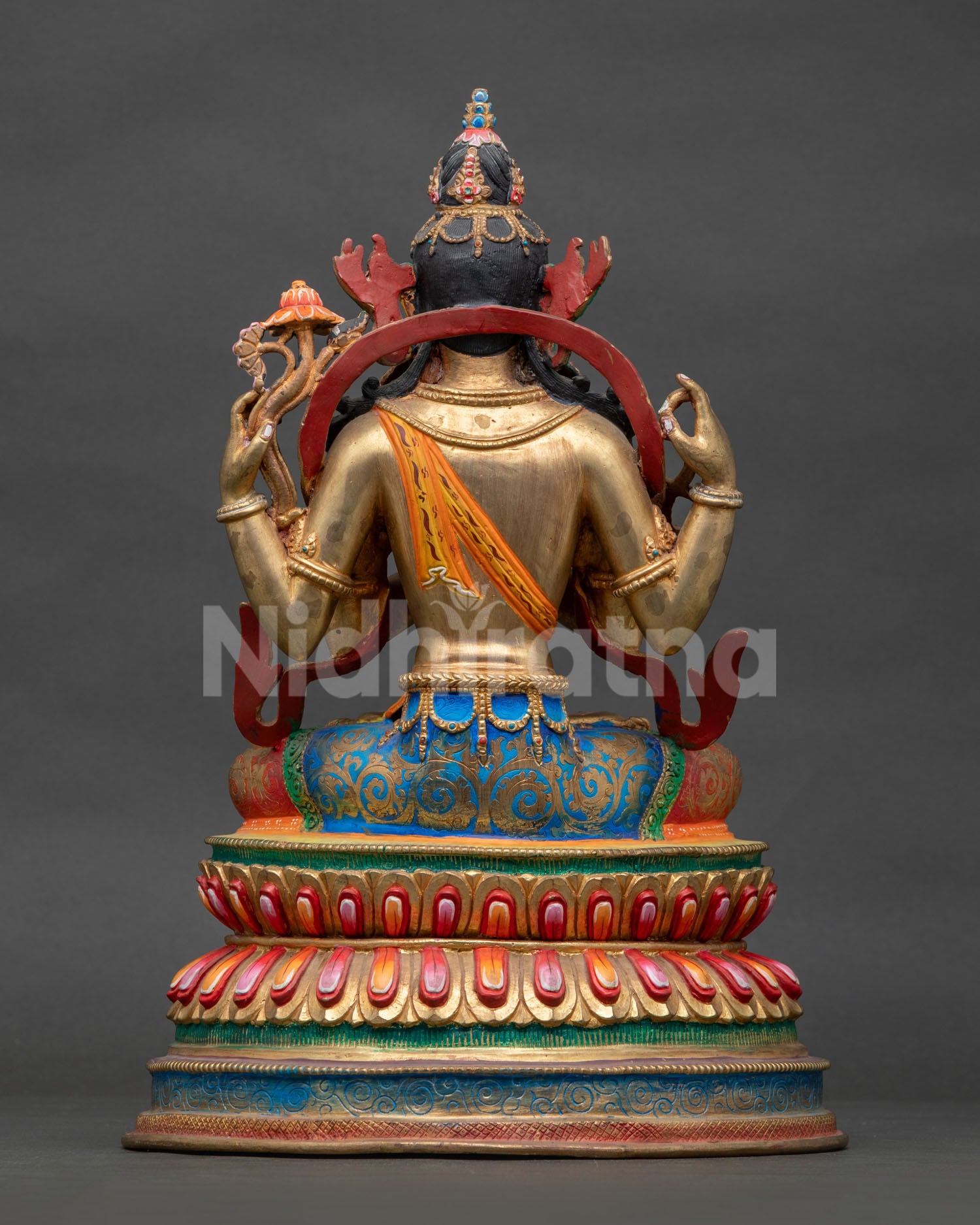 Four-Armed Chenrezig Statue seated on multi-color double lotus pedestal.
