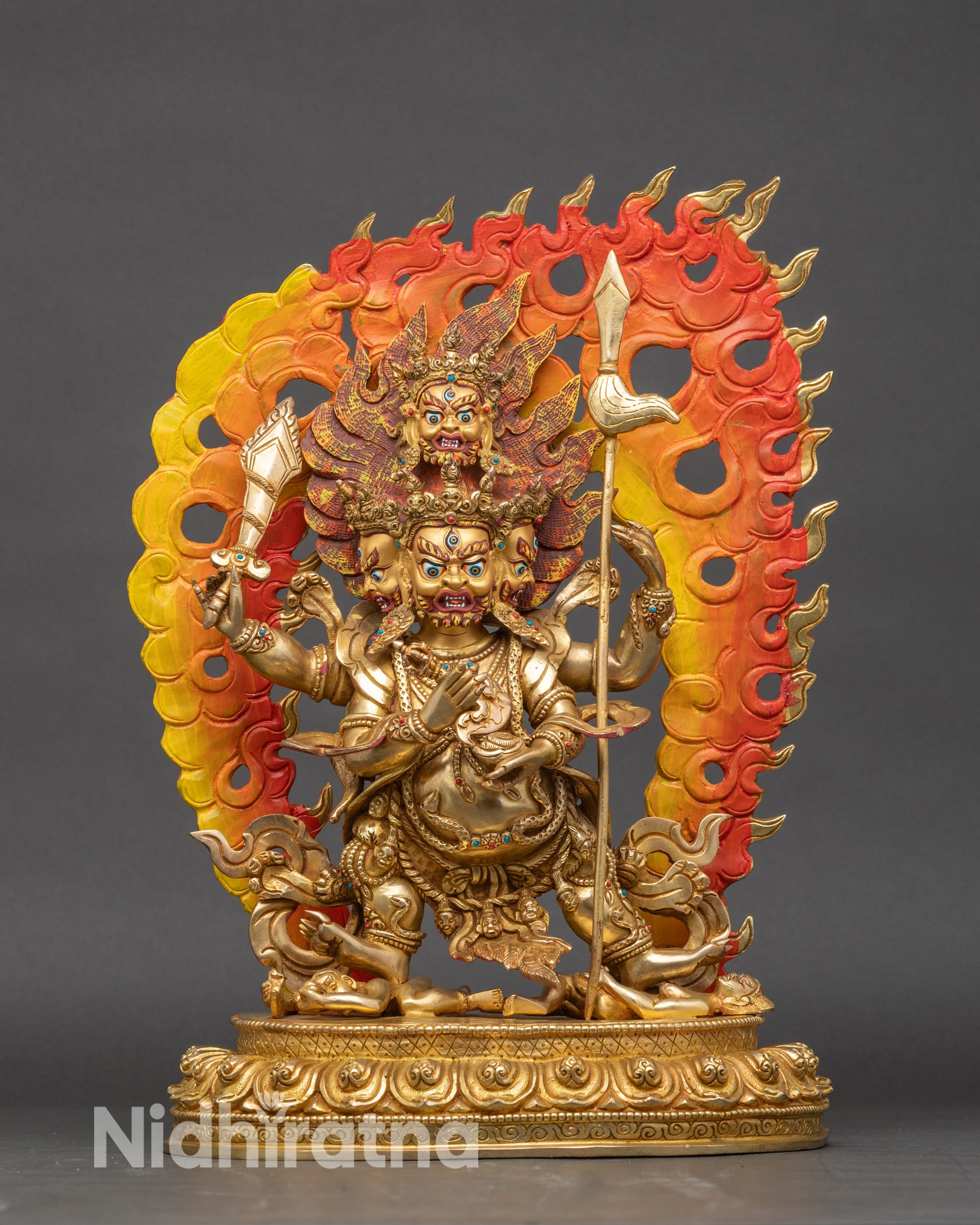 Four-Armed Mahakala statue, gilded copper, three faces and four arms with ritual implements