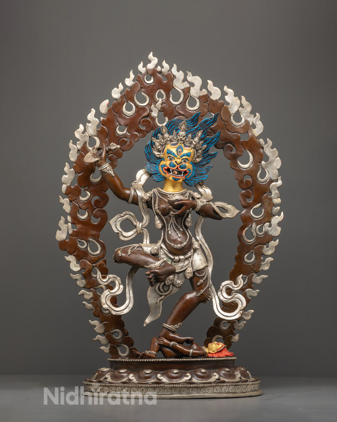 Front-facing hand-carved Singha Mukha Statue with oxidized copper body