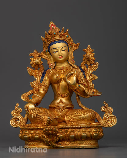 Front view of Green Tara statue gold-painted face lotus pedestal handcrafted Nepalese Buddhist art