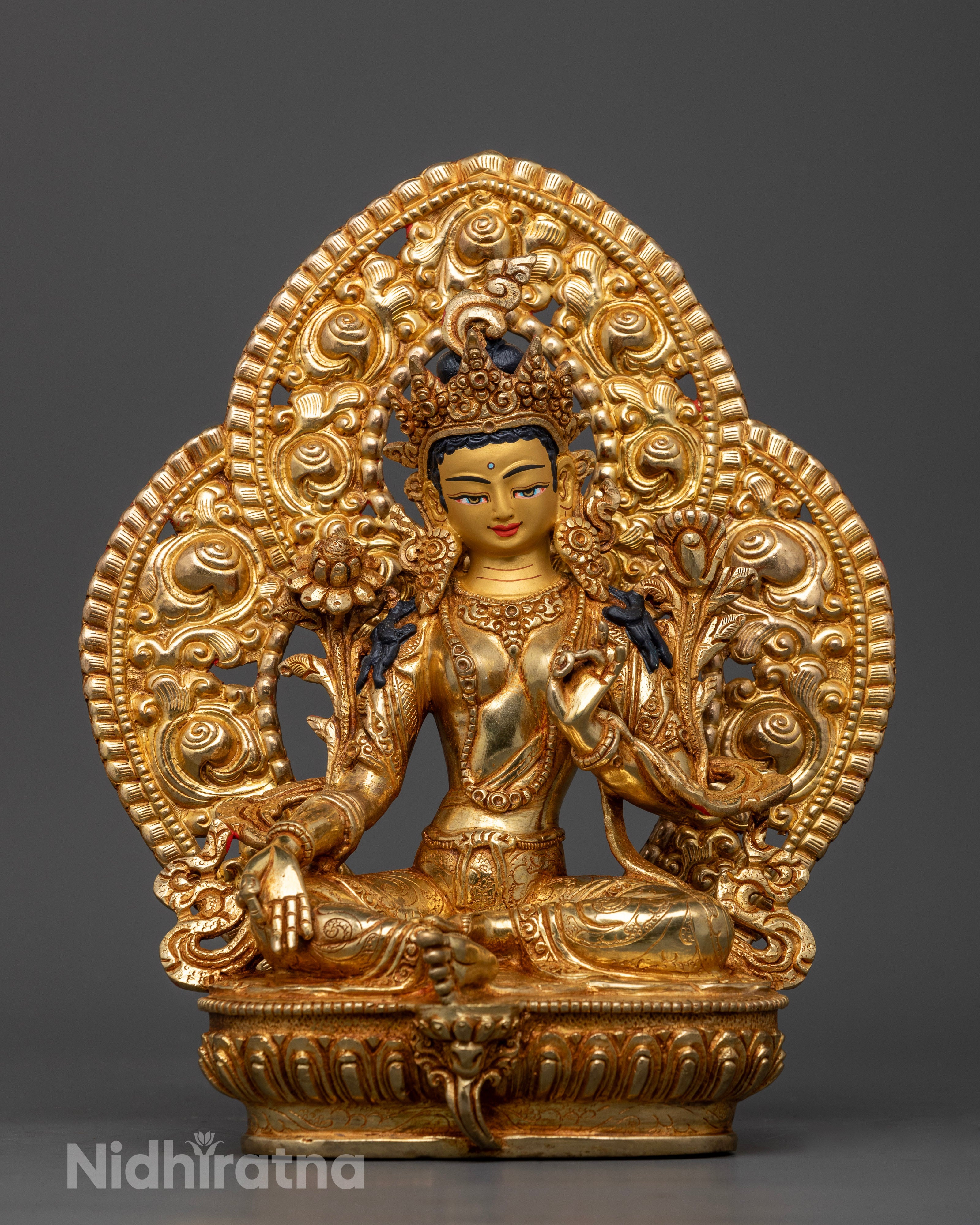 Front view of Green Tara statue gold-painted face lotus pedestal handcrafted Nepalese deity
