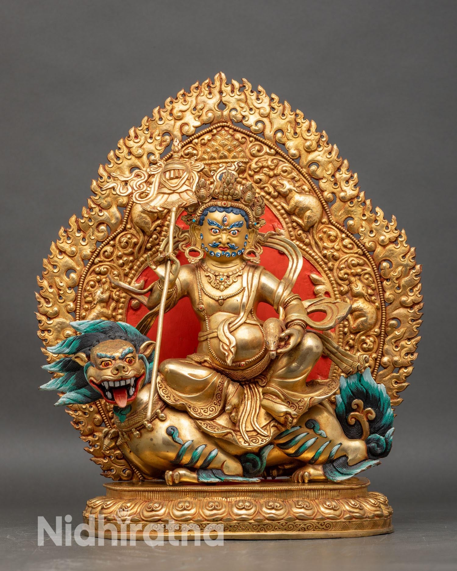Front view of Namtoshe statue, seated on snow lion gold fire-gilded copper semi-precious stones