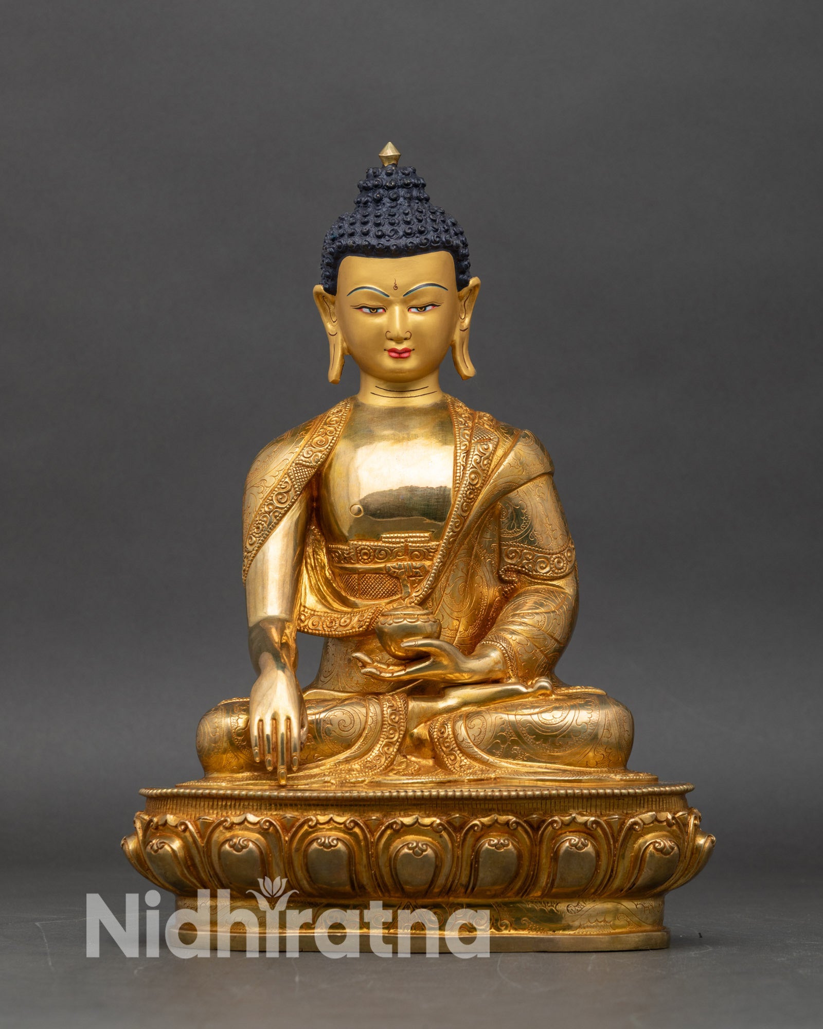 Front view of Shakyamuni Gautam Buddha Statue with gold-painted serene face holding begging bowl