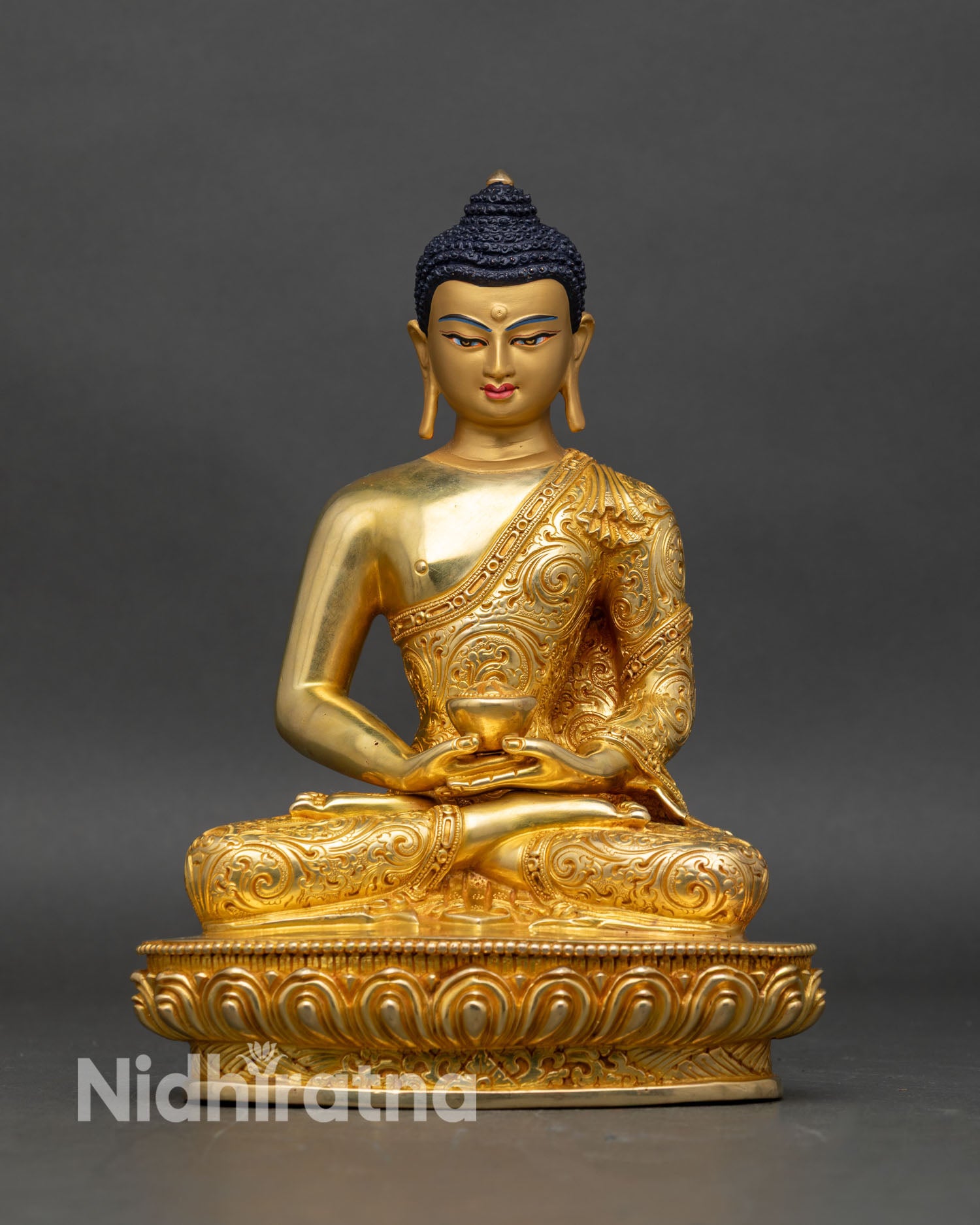 Front view of Amitabha Buddha statue, gold fire-gilded, seated on lotus throne