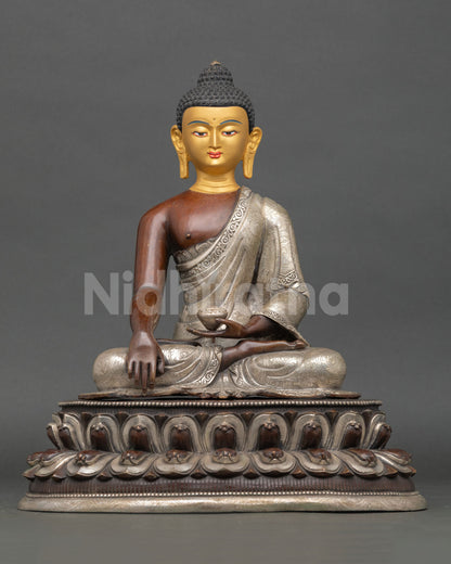 Front view of handmade Shakyamuni Buddha statue in copper and silver with 24K gold-painted face on lotus pedestal