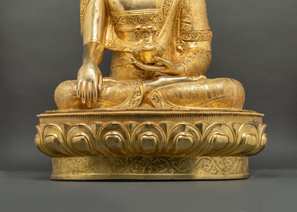 Front view of Shakyamuni Buddha statue seated on gold lotus throne