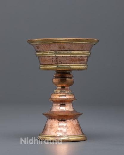 Front-view Artisan-crafted copper butter lamp from Nepal with intricate hammered details