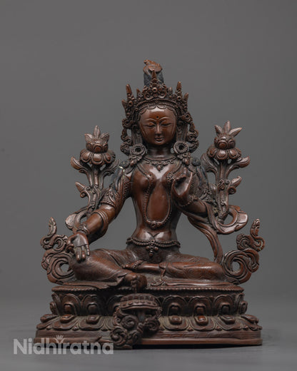 Front-view of Hand-carved Green Tara statue seated on oxidized copper double lotus base