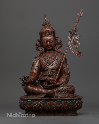 Front-view of Handcrafted oxidized copper Guru Rinpoche statue seated on a lotus base with skull cup
