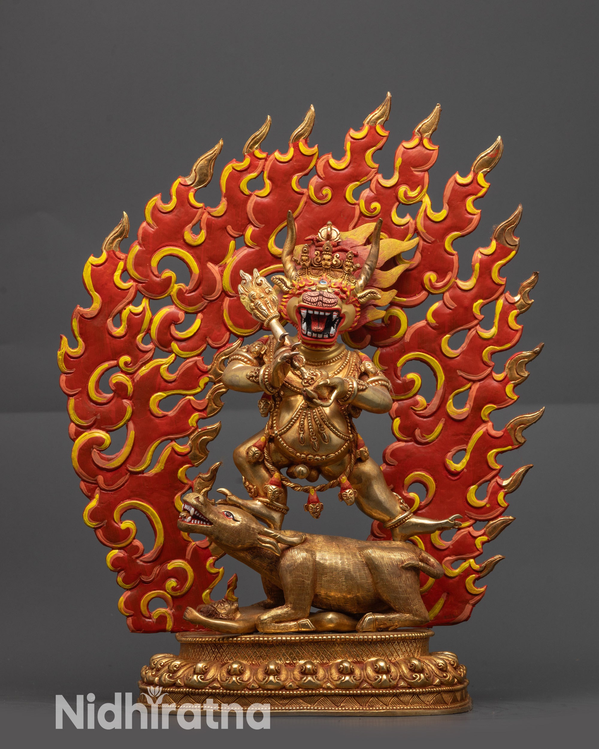 Front view of 15-inch Handmade Golden Yamantaka Statue with fiery backdrop, standing on buffalo – Tibetan Buddhist Yidam deity sculpture from Nepal